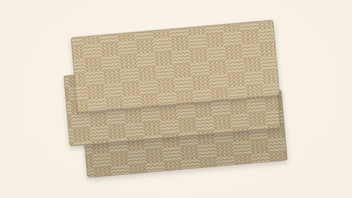 A basketweave textured knitted scarf in oatmeal with clear woven-looking blocks