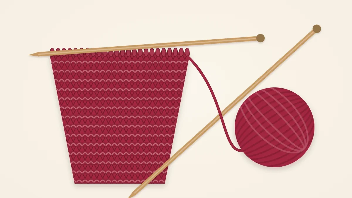 A scarf in progress on the needles that visibly widens toward the top, in berry yarn