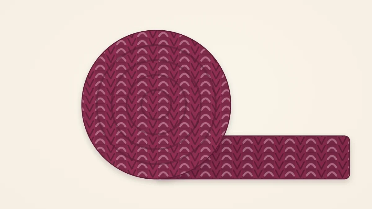 A chunky ribbed scarf in mulberry rolled into a loose coil
