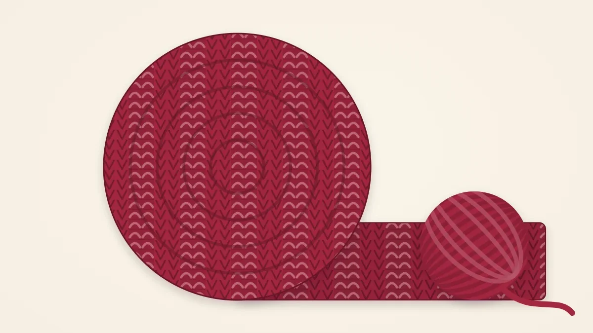 A thick, wide ribbed scarf in deep berry red coiled in generous loops
