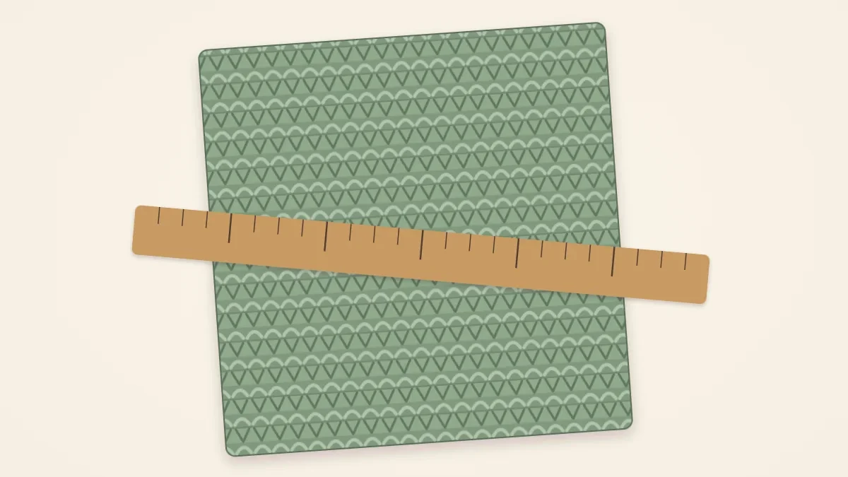 A square knitted swatch with a ruler lying across it