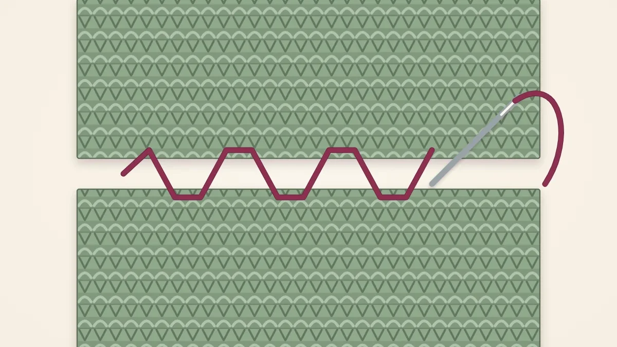 Two ends of a scarf placed edge to edge with a tapestry needle and yarn stitching them together
