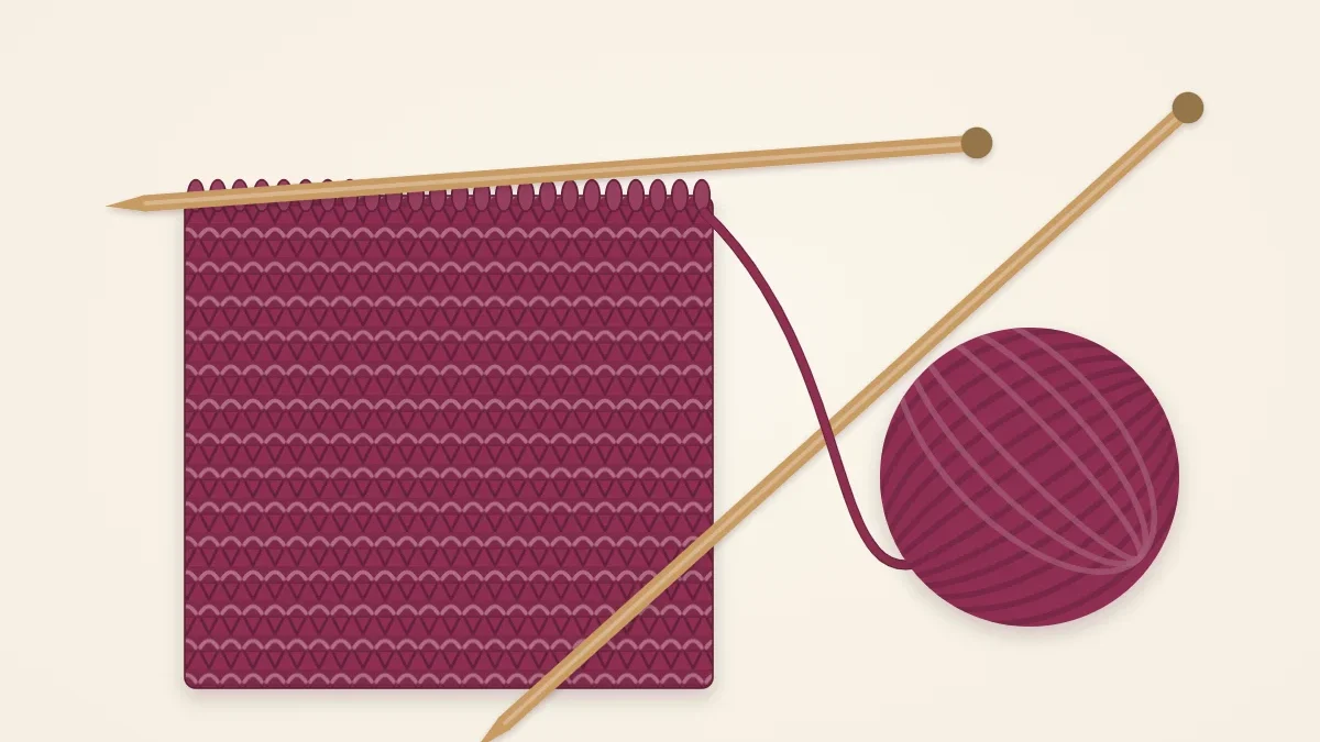 A garter stitch scarf in progress in mulberry yarn on a pair of wooden needles, with the ball of yarn beside it