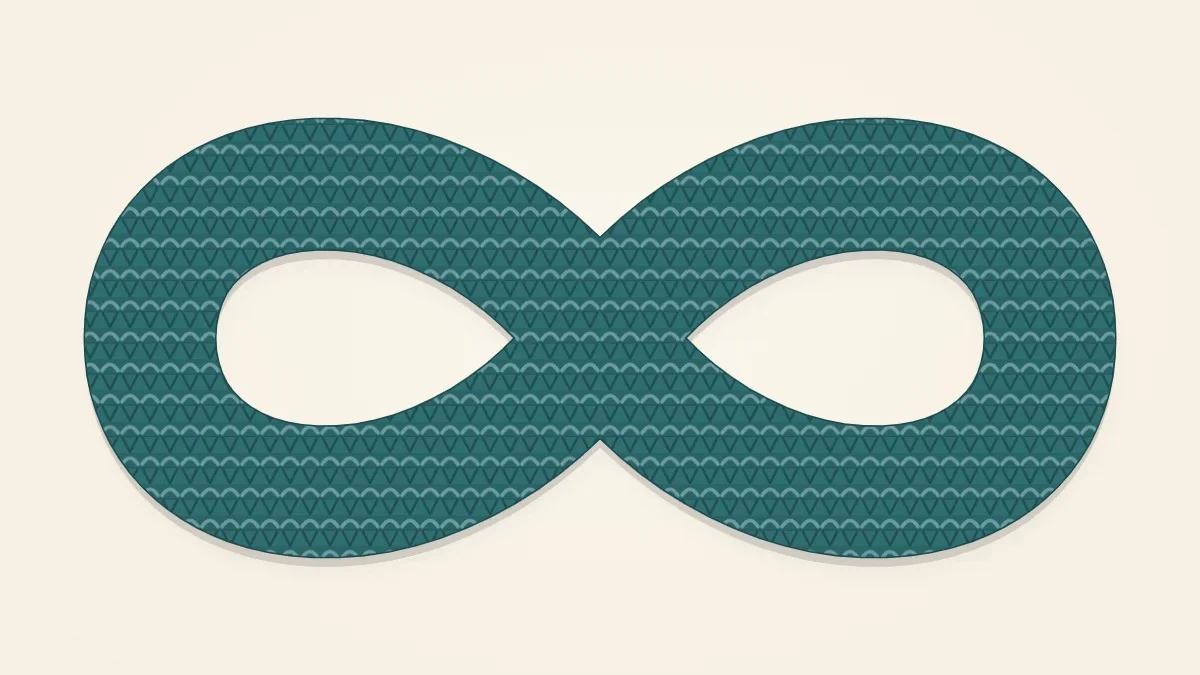 An infinity scarf loop in teal laid in a figure-eight