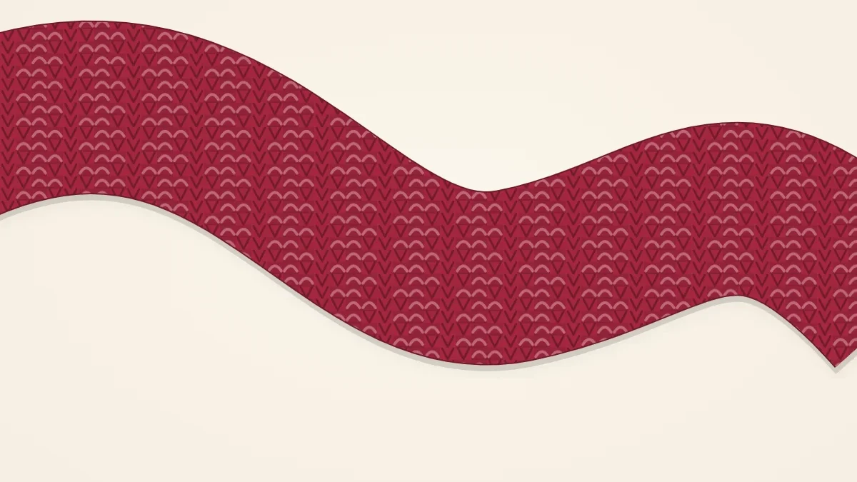 A mistake rib knitted scarf in berry red with deep, slightly offset ribs