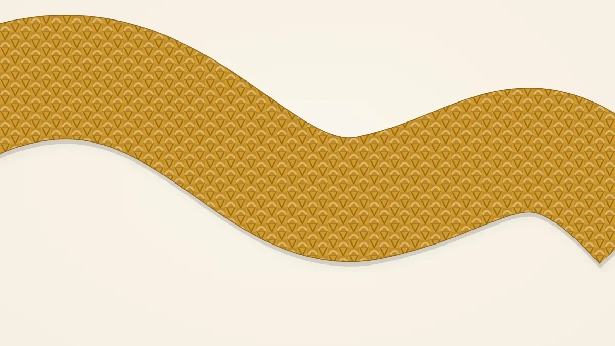 A seed stitch scarf in mustard with a pebbly, dotted texture