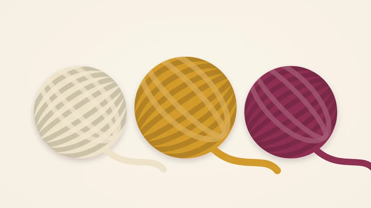 Three fat balls of super bulky yarn in cream, mustard and mulberry